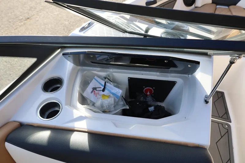 Slide: The Image of Open storage compartment in 2023 Tigé Z3 boat with cup holders and accessories. - 59