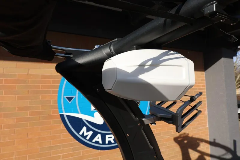 Slide: The Image of 2023 Tigé Z3 boat tower with speaker, against a brick wall and marina logo. - 61