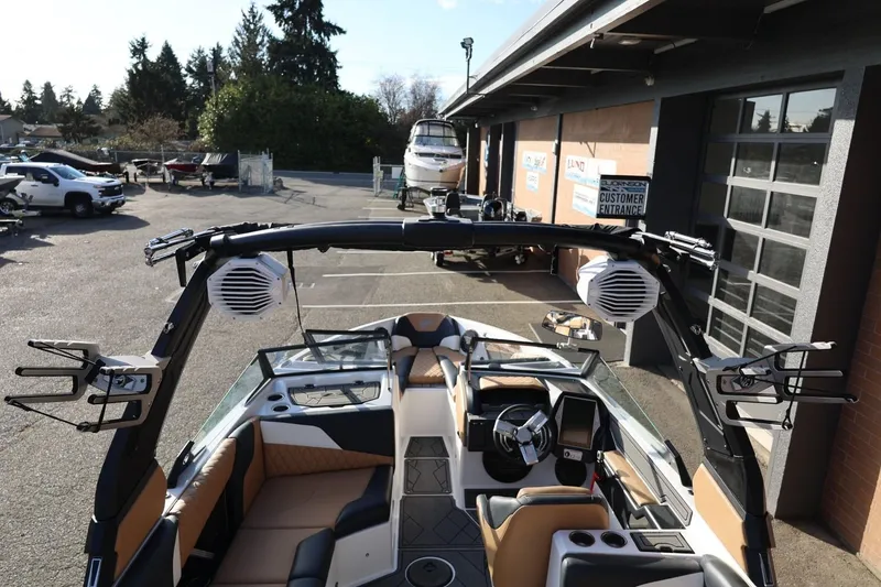 Slide: The Image of 2023 Tigé Z3 boat interior with advanced dashboard and speakers, parked outside dealership. - 62