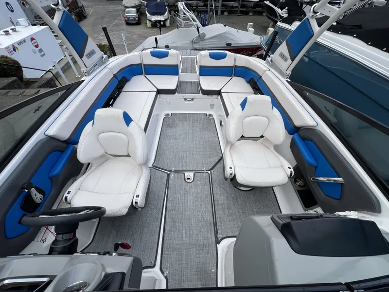 Slide: The Image of Interior of a 2017 Chaparral Vortex 2430 VRX boat with blue and white seating. - 15