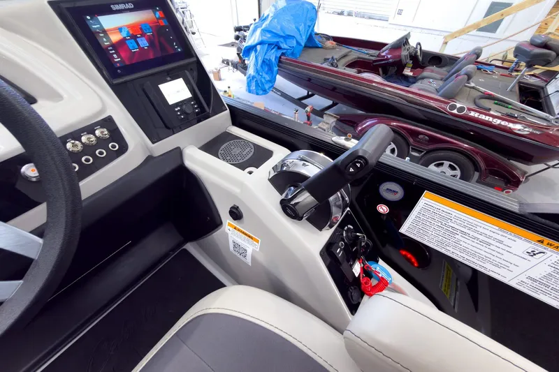 Slide: The Image of Interior of 2025 Barletta Cabrio 22UC boat with control panel and steering wheel. - 17
