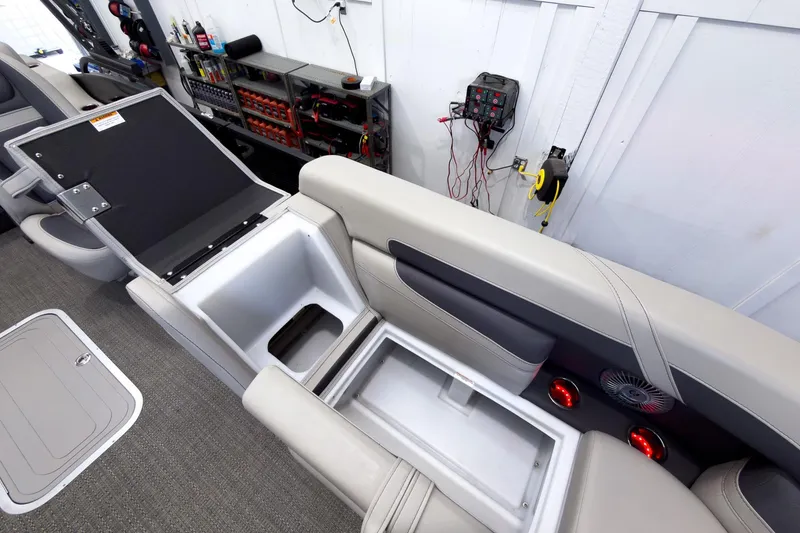 Slide: The Image of 2025 Barletta Cabrio 22UC boat interior with open storage compartments and modern seating. - 21