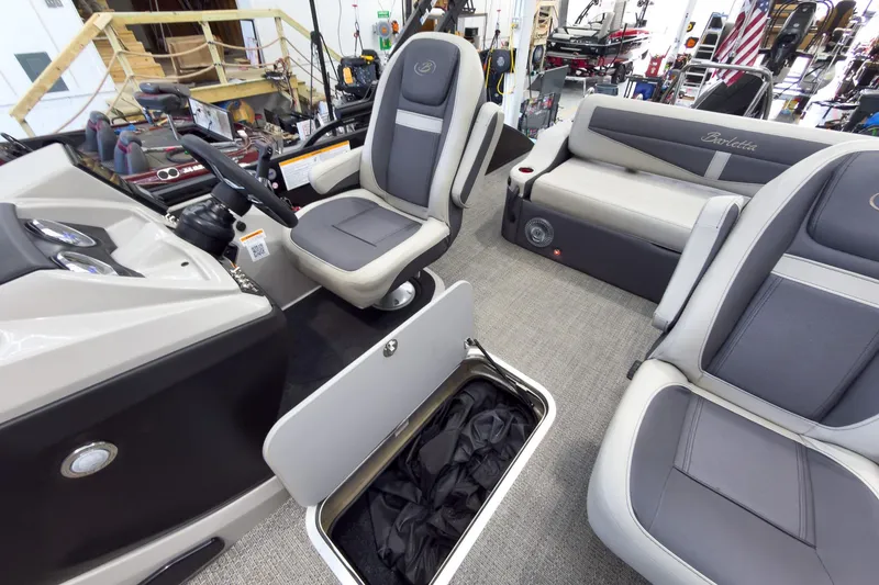 Slide: The Image of 2025 Barletta Cabrio 22UC interior with plush seating and storage compartment. - 22