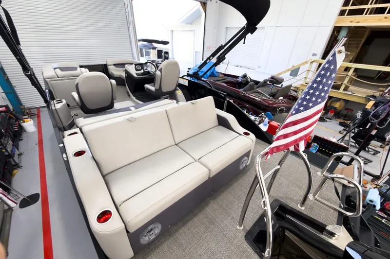 Slide: The Image of 2025 Barletta Cabrio 22UC pontoon boat interior with seating and American flag. - 28
