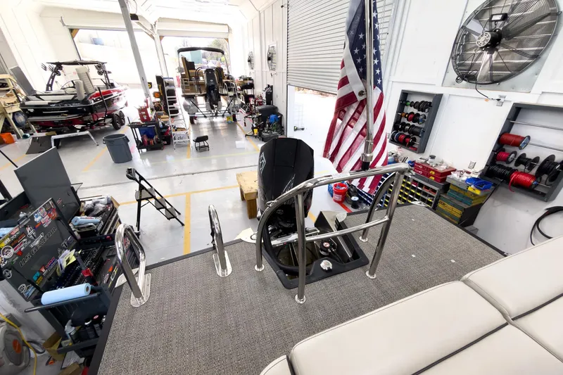 Slide: The Image of 2025 Barletta Cabrio 22UC in a workshop with tools and American flag. - 29