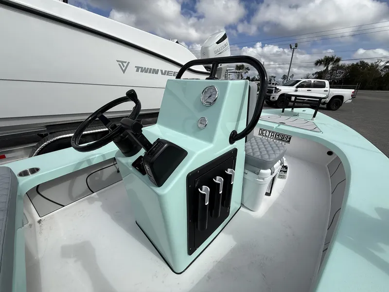 Slide: The Image of Delta Boatworks D18 CC Guide Series 2026, steering console and seating area. - 10