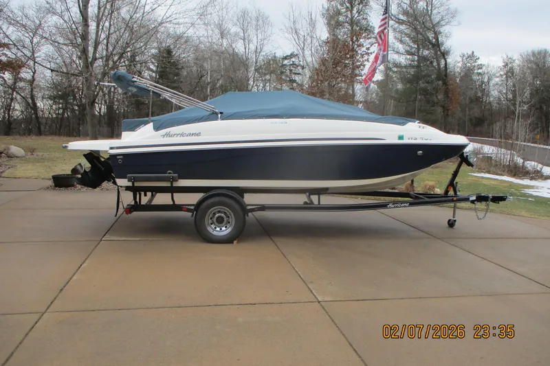 Slide: The Image of 2016 Hurricane FunDeck GS 188 IO boat on trailer, covered, parked on driveway. - 3