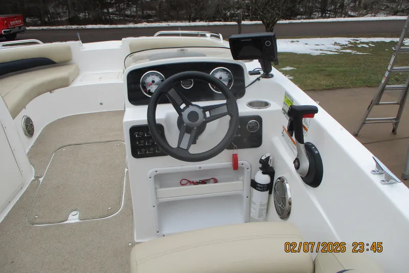 Slide: The Image of 2016 Hurricane FunDeck GS 188 IO boat cockpit with steering wheel and controls. - 5