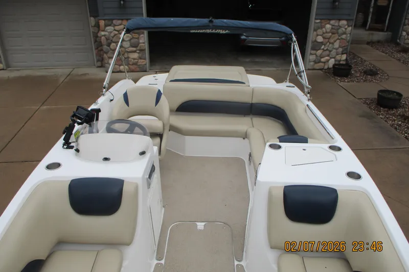 Slide: The Image of 2016 Hurricane FunDeck GS 188 IO boat with beige and blue seating, docked outdoors. - 6