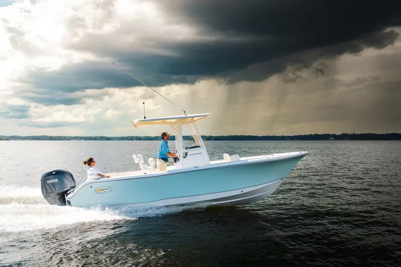 Slide: The Image of Sea Hunt Ultra 229 boat 2026 on water under dramatic sky. - 5