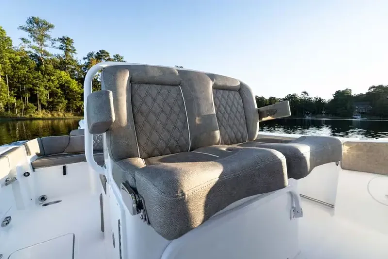 Slide: The Image of 2026 Sea Hunt Ultra 275 CB boat seats by the lake. - 4