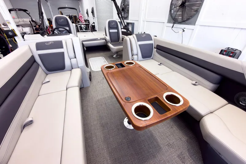Slide: The Image of Luxurious interior of 2025 Barletta Cabrio 24UC pontoon boat with elegant seating and wooden table. - 11