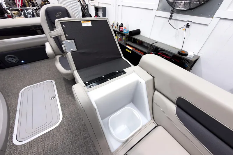 Slide: The Image of 2025 Barletta Cabrio 24UC boat interior with open storage compartment and seating. - 13
