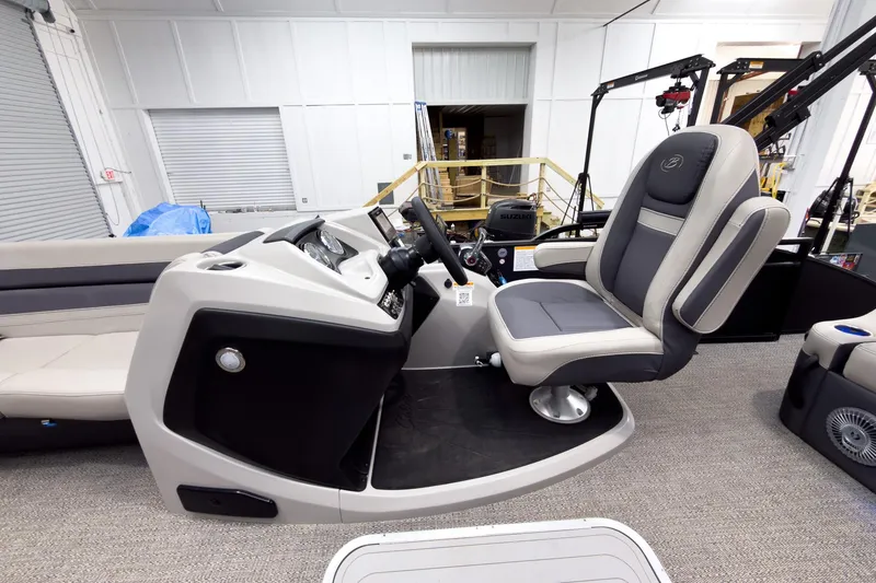 Slide: The Image of 2025 Barletta Cabrio 24UC boat interior with captain's chair and control console. - 15