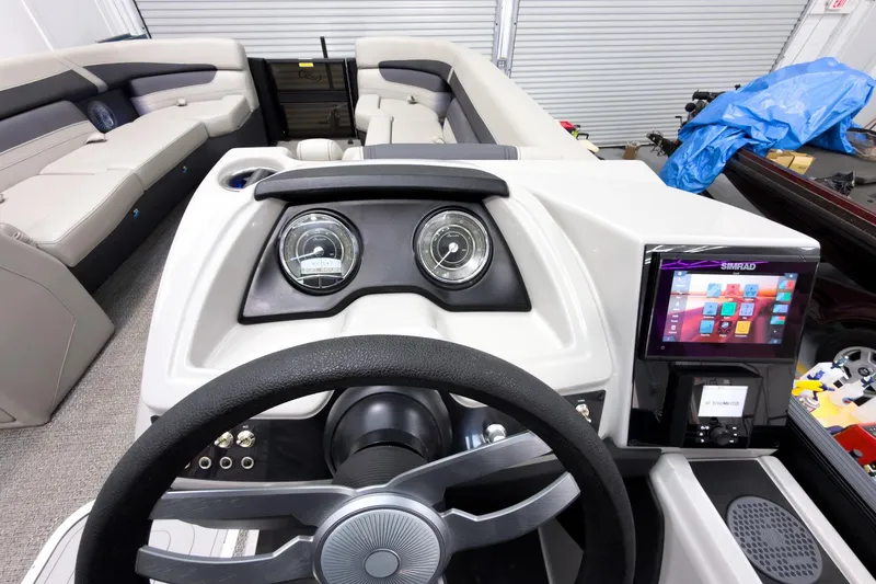 Slide: The Image of 2025 Barletta Cabrio 24UC boat dashboard with modern controls and touchscreen display. - 16