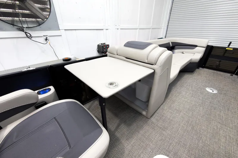 Slide: The Image of 2025 Barletta Cabrio 24UC interior with plush seating and a foldable table. - 21
