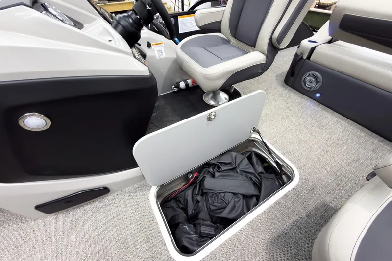 Slide: The Image of 2025 Barletta Cabrio 24UC boat interior with storage compartment and seating. - 22
