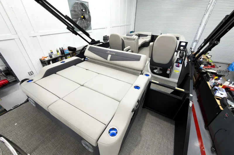 Slide: The Image of 2025 Barletta Cabrio 24UC pontoon boat interior with plush seating and modern controls. - 25
