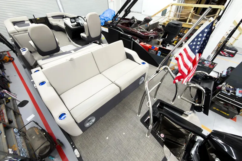 Slide: The Image of 2025 Barletta Cabrio 24UC pontoon boat interior with seating and American flag. - 30