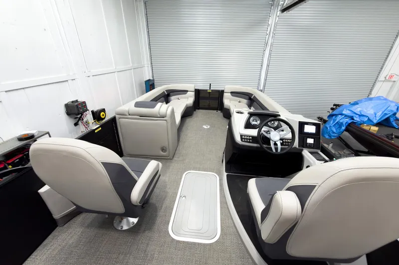 Slide: The Image of 2025 Barletta Cabrio 24UC pontoon boat interior with modern seating and control panel. - 32