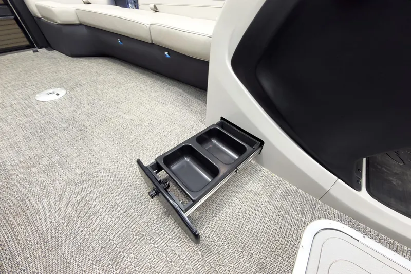 Slide: The Image of 2025 Barletta Cabrio 24UC interior with retractable cup holders and beige seating. - 34