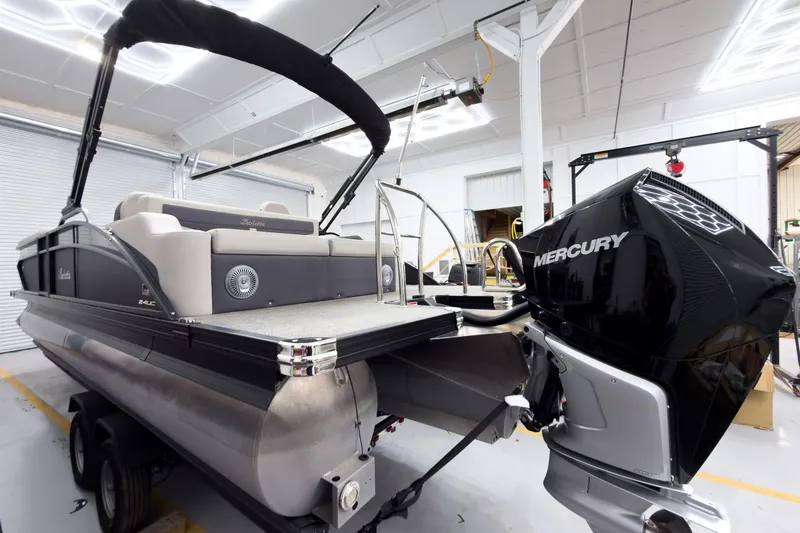 Slide: The Image of 2025 Barletta Cabrio 24UC pontoon boat with Mercury engine in a showroom. - 4