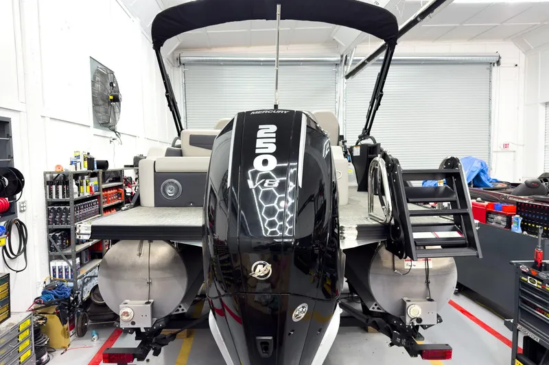 Slide: The Image of 2025 Barletta Cabrio 24UC pontoon boat with Mercury 250 V8 engine in a workshop. - 5