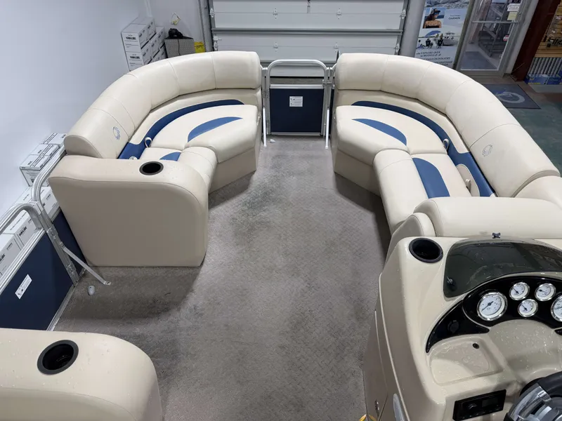 Slide: The Image of Interior of a 2014 Lowe SS 210 pontoon boat with beige seating. - 13