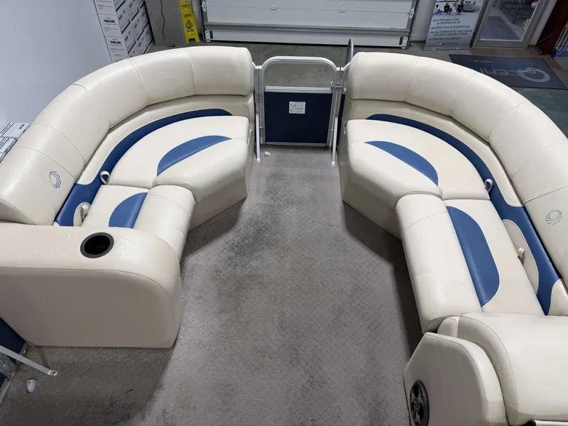Slide: The Image of Interior of a 2014 Lowe SS 210 pontoon boat with blue and beige seating. - 14