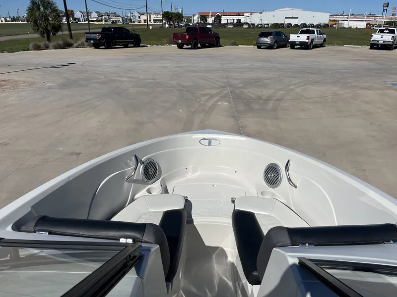 Slide: The Image of Interior view of a 2016 Tahoe 550 TS boat on a parking lot. - 13