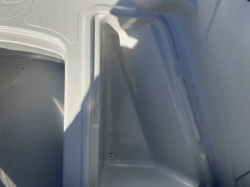 Slide: The Image of Interior of a 2016 Tahoe 550 TS boat, white plastic material. - 15