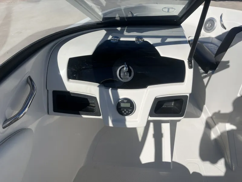Slide: The Image of Interior view of a 2016 Tahoe 550 TS boat with control console. - 27