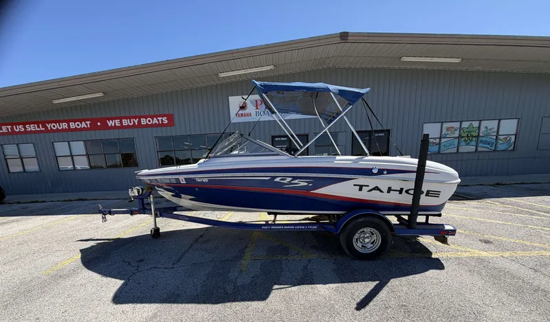 Slide: The Image of 2013 TAHOE Q5i boat on trailer outside a boat dealership. - 3