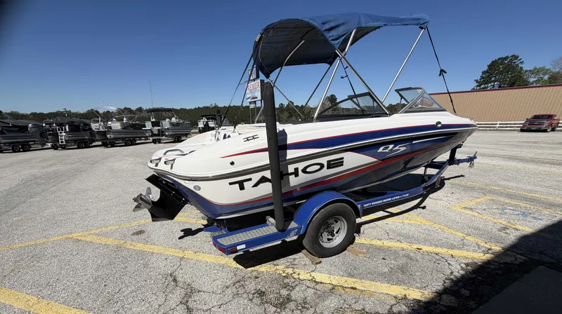 Slide: The Image of 2013 TAHOE Q5i boat on trailer parked outdoors. - 5