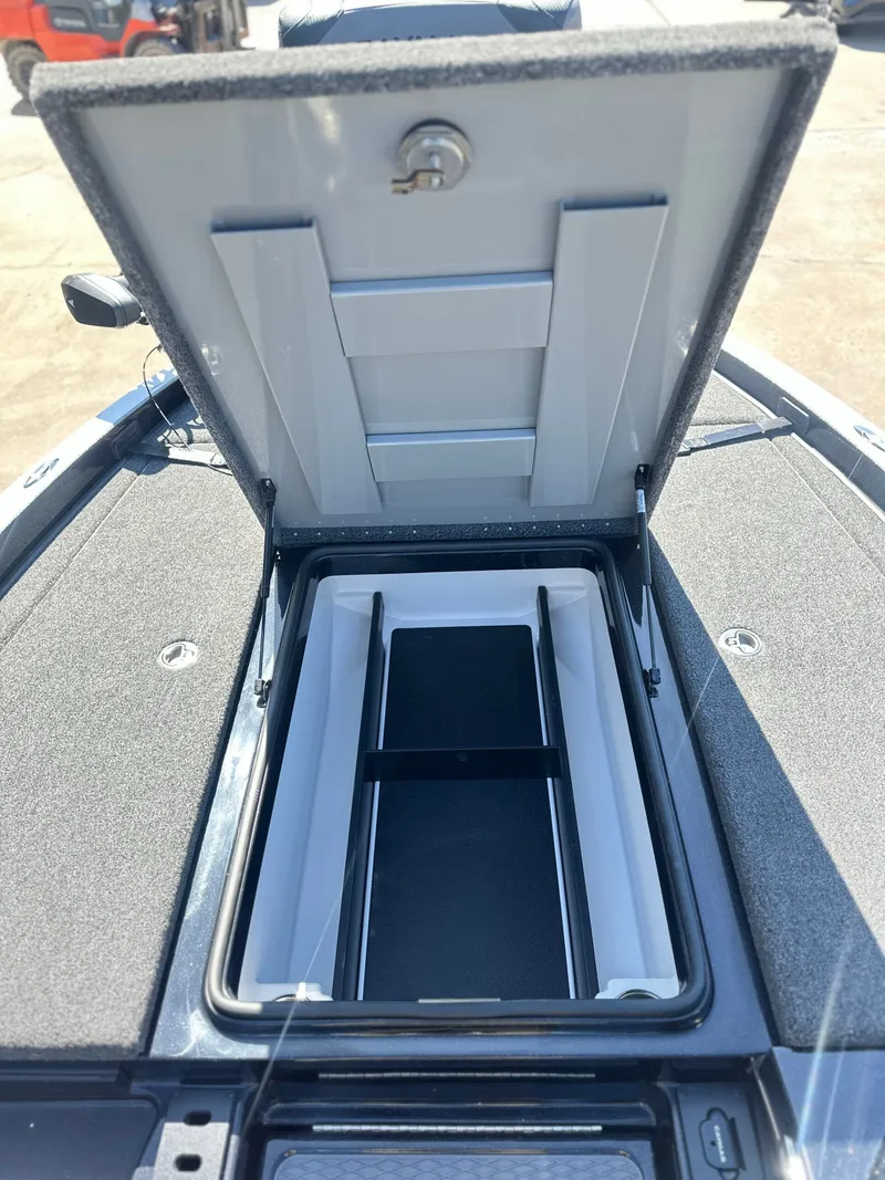 Slide: The Image of Open storage compartment of a 2027 Caymas CX 201 PRO boat. - 13