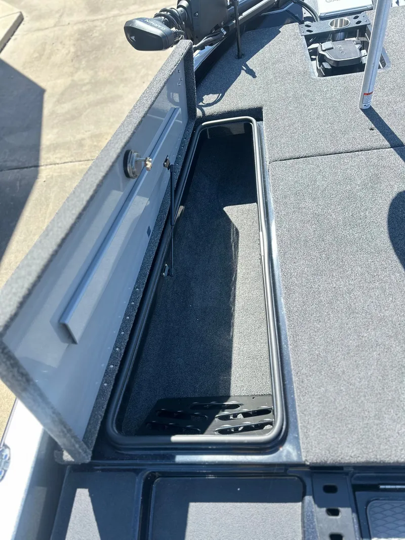 Slide: The Image of Open storage compartment on a 2027 Caymas CX 201 PRO boat. - 15