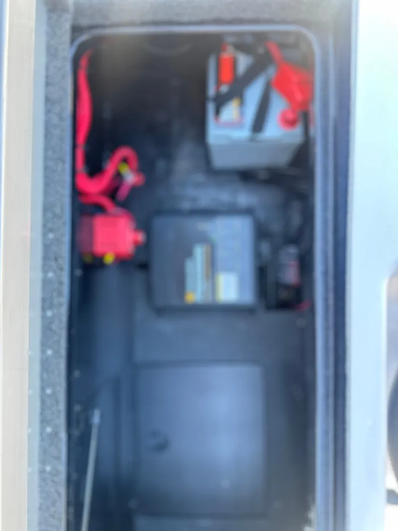 Slide: The Image of Battery compartment of 2027 Caymas CX 201 PRO with red cable. - 22