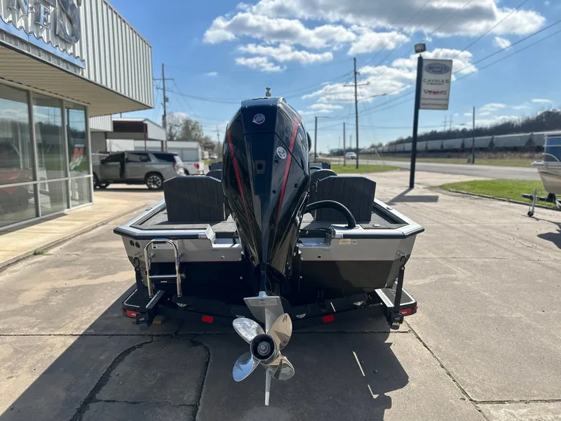 Slide: The Image of Rear view of Vexus AVX 1985s boat, 2026 model, parked outdoors. - 3