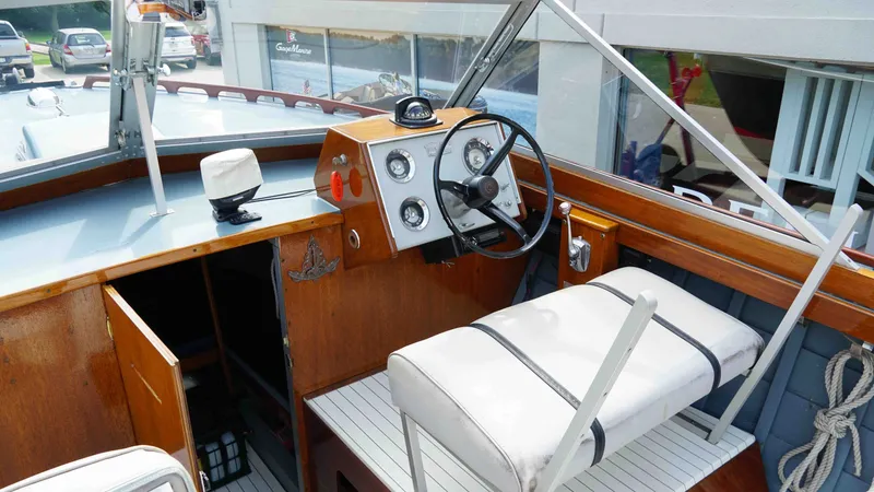 Slide: The Image of Interior of a 1966 Chris-Craft Sea Skiff boat with steering wheel and seats. - 9