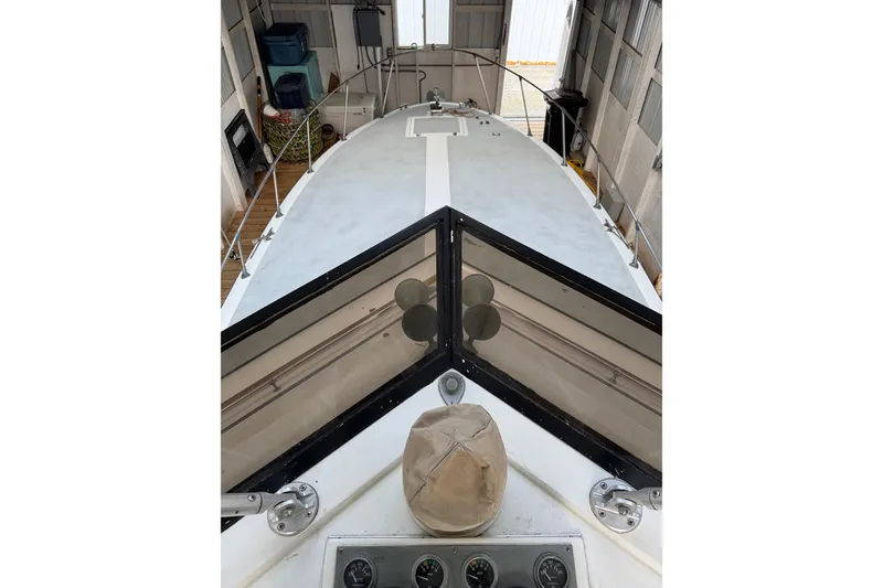 Slide: The Image of 1974 Magnum Sportfisher boat deck view inside a storage facility. - 12