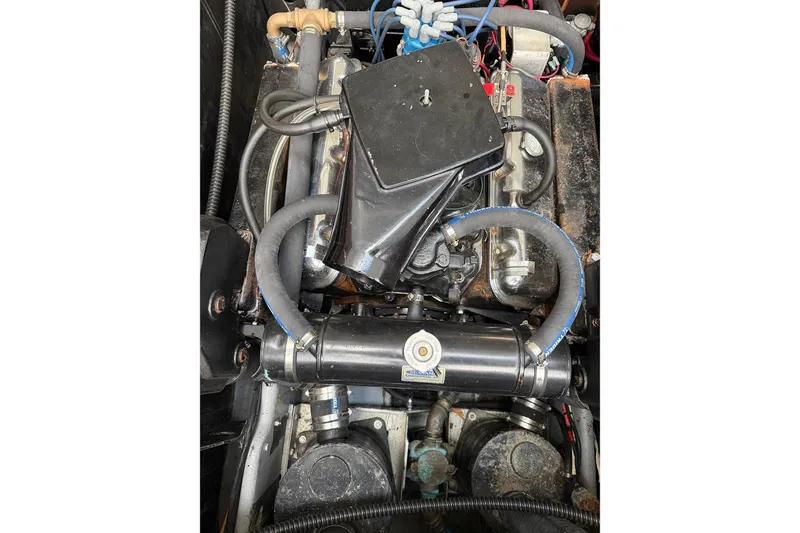 Slide: The Image of 1974 Magnum Sportfisher engine with hoses and components visible. - 22