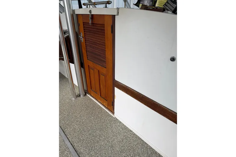 Slide: The Image of 1974 Magnum Sportfisher interior with wooden door and white paneling. - 7