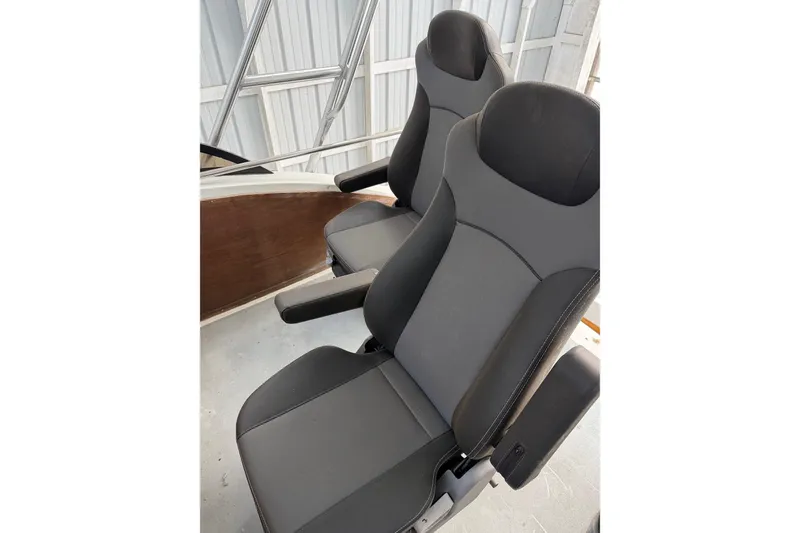 Slide: The Image of Two modern black and gray seats on a 1974 Magnum Sportfisher boat. - 9