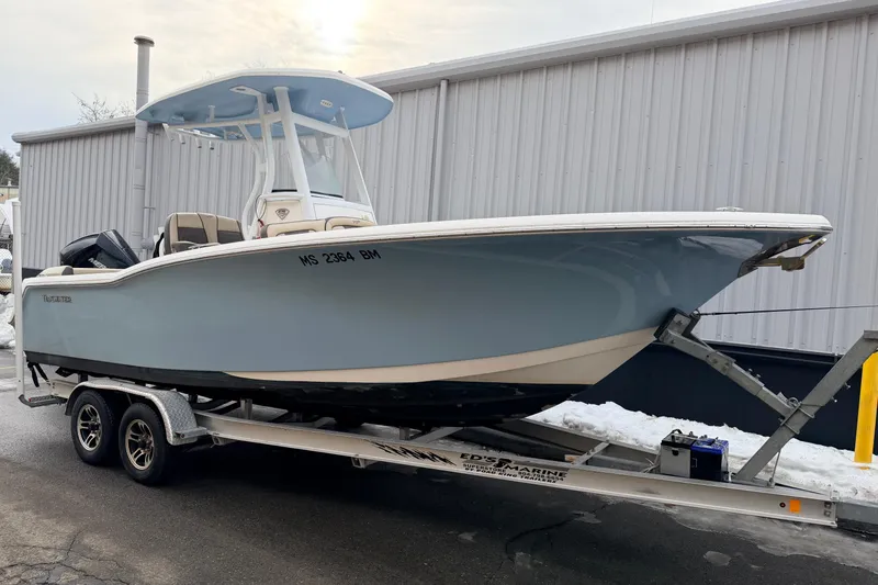 The Image of 2018 Tidewater 232 SS boat on trailer, parked near a building. - 0