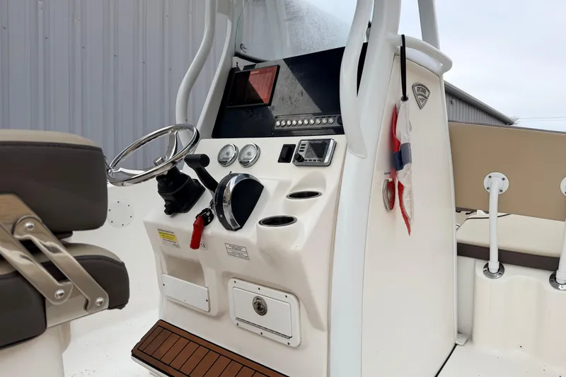 Slide: The Image of 2018 Tidewater 232 SS boat console with steering wheel and control panel. - 10