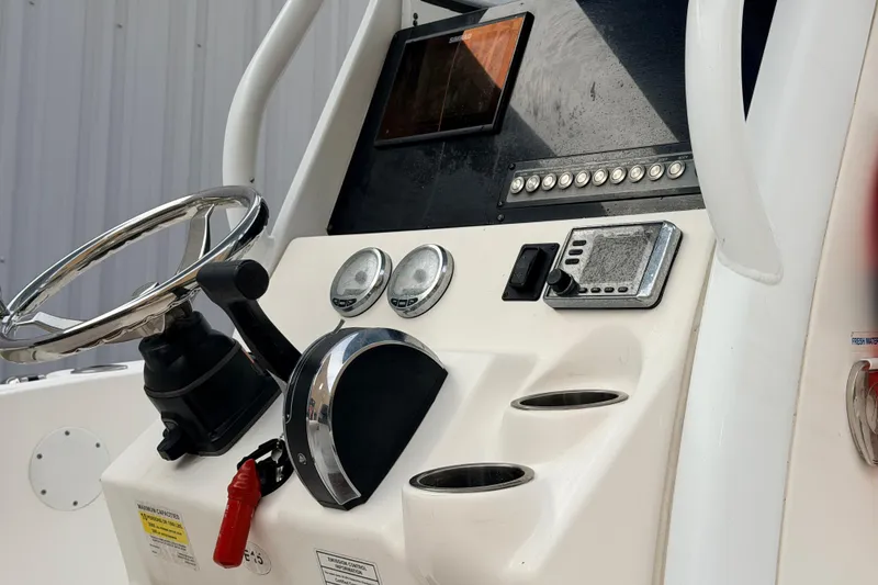 Slide: The Image of Control panel of a 2018 Tidewater 232 SS boat with steering wheel and gauges. - 11