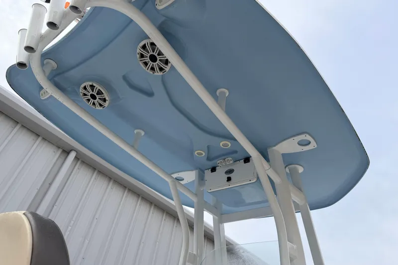 Slide: The Image of 2018 Tidewater 232 SS boat's blue T-top with speakers and rod holders. - 13