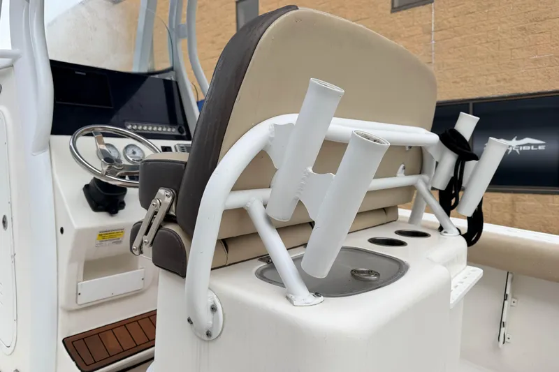 Slide: The Image of 2018 Tidewater 232 SS boat interior with steering wheel and rod holders. - 16