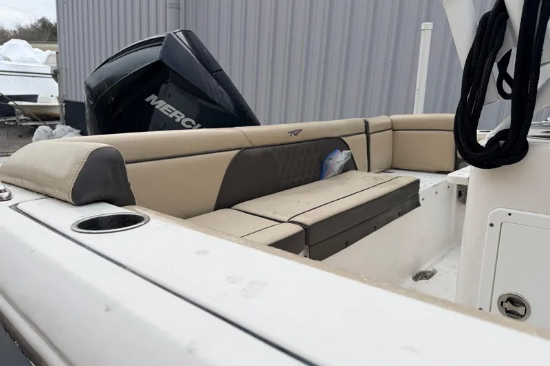 Slide: The Image of 2018 Tidewater 232 SS boat interior with beige seating and Mercury engine. - 18