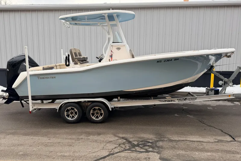 Slide: The Image of 2018 Tidewater 232 SS boat on trailer, light blue hull, parked outdoors. - 3